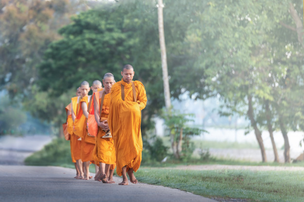 The monk walking for receive food at morning